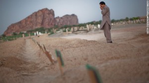 A man cries as he prays at the graves of the victims from the May Lahore attacks against Ahmadiyya community mosques July 14, 2010 in Chenab Nagar, Pakistan.