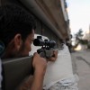 A fighter from the Syrian opposition aim